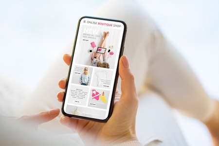 Woman shopping online on her mobile phoneの写真素材