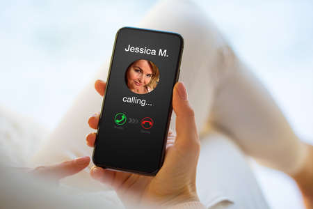 Woman receiving a phone call from her friendの写真素材
