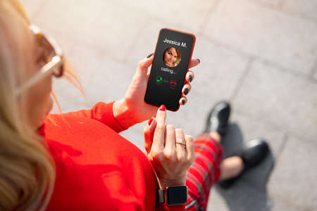 Woman receiving call from her friendの写真素材