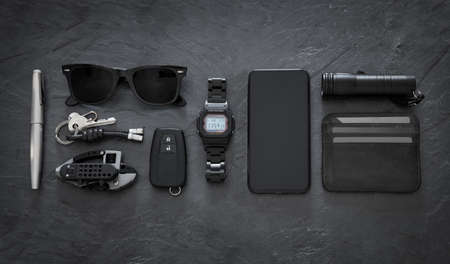 Set of EDC (Every Day Carry) items on dark backgroundの写真素材