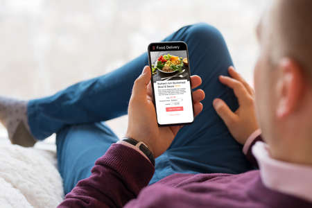 Man choosing a meal on food delivery appの写真素材