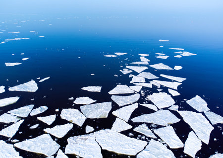Ice melting in blue sea water