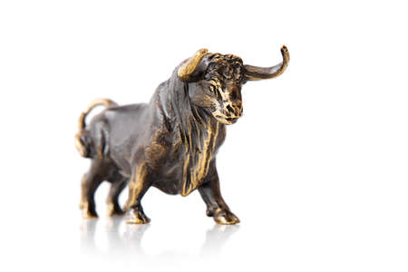 Bull figurine isolated on white backgroundの写真素材