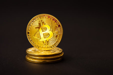 Golden coins with bitcoin on dark backgroundの写真素材