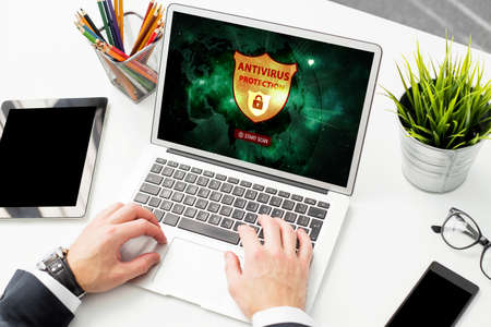 Man using antivirus protection software on computerの写真素材