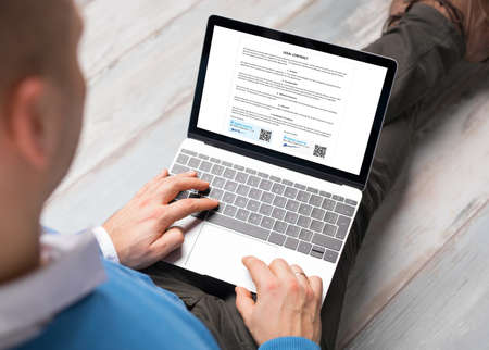 Man using digital signature for signing contract on computerの写真素材