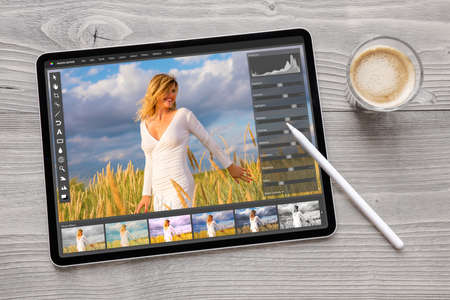 Concept of digital photo editing on tablet computer with wireless stylus penの写真素材