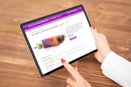 Woman buying hand made soap onlineの写真素材