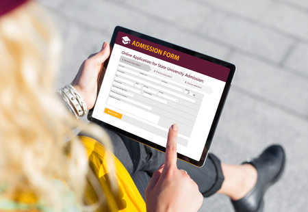 Student submitting online admission form on tablet computer