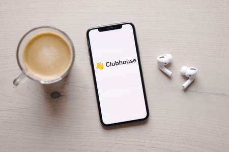 Riga, Latvia - April 11, 2021: Mobile phone with Clubhouse logo on the screenのeditorial素材