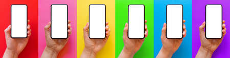 Mockup of mobile phone in hand, set of images on different bright colored backgroundsの写真素材