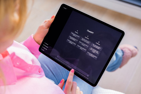 Madrid, Spain - January 12, 2023: Woman looking at ChatGPT on iPad, AI or artificial intelligence...