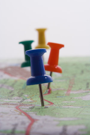Pushpins put into a map - blue in front, took against the light