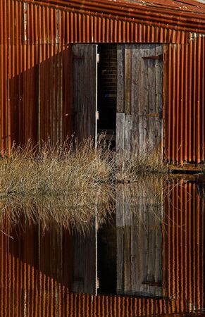 Old wooden doors by water.の写真素材