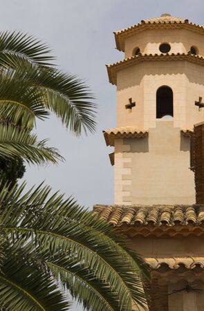 Church tower with palm tree to leftの写真素材