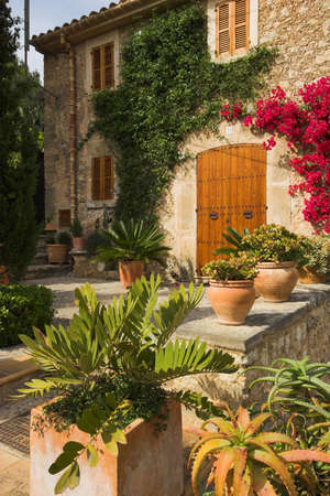 Garden with path leading to double doors. Pots in forgroundの写真素材