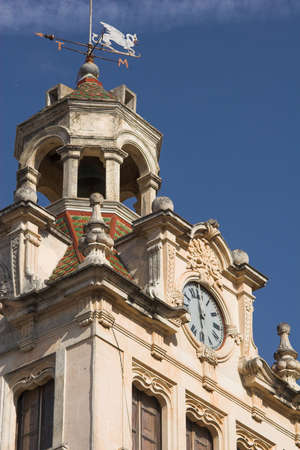 Town hall tower and clock against a blue skyの写真素材