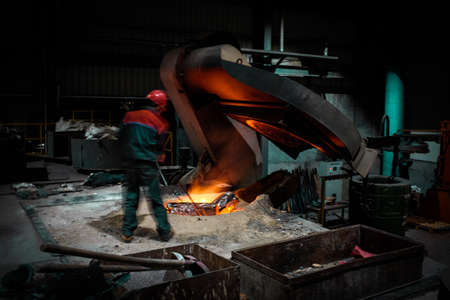Foundry worker melting metal for casting spare partsの写真素材