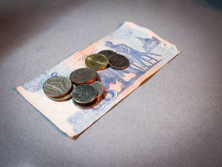 Thai 50 baht note with some coins.の写真素材
