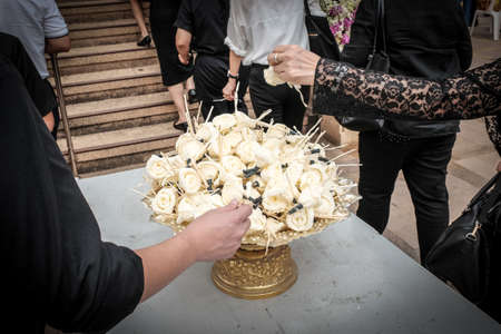 People picking Paper flower at a Buddhist funeral. Thailandの写真素材