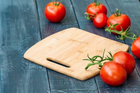 Fresh tomatoes on rustic wooden background. Ingredient for saladの写真素材