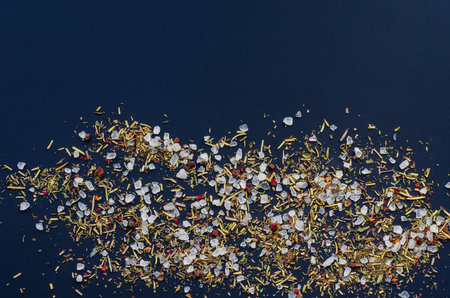 coarse grinding of sea salt. Ground spices and herbs. Dark background.の写真素材