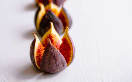 Ripe figs on a white wooden background. Treatment of anemia. Potassium for the heart.の写真素材