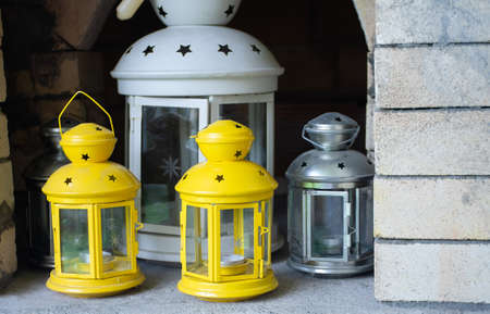 Yellow and white candlesticks made of metal. Candlestick in the form of a lantern.の写真素材