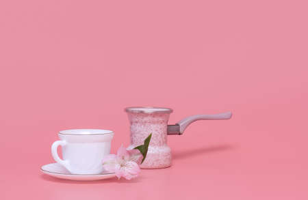 Minimalism style. One cup of coffee and coffee maker on a pink background, coffee turkaの写真素材