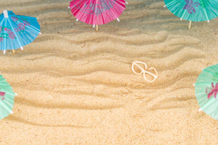 Umbrellas on the sandy beach. Tropical vacation background. Copy space, top viewの写真素材