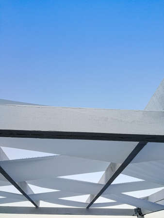 Protective awning from the sun against the blue sky. Mobile photo, vertical frameの写真素材