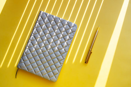 Notebook and pen on a yellow background. View from above. The concept of business ideas. Minimalism. flat lay designの写真素材