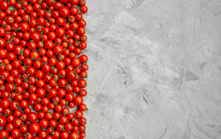 Cherry tomato pattern on a gray background. Flat lay, top view.の写真素材