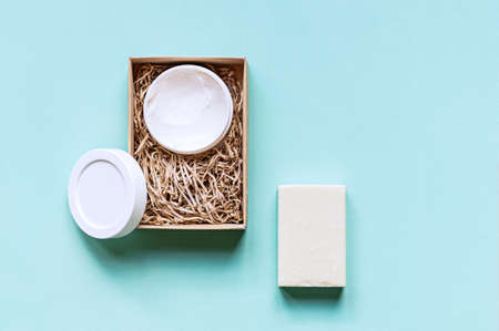 Flat composition with handmade soap and hand cream on a mint background. The concept of natural cosmetics. Copy space.の写真素材