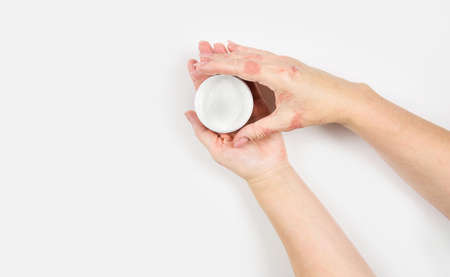 Cream for the treatment of dermatitis. Female hands, close-up. Flat lay.の写真素材