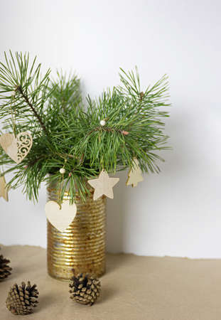 Christmas composition in vintage style. Pine branches and cones, home made wooden decorations. Vertical frame.の写真素材
