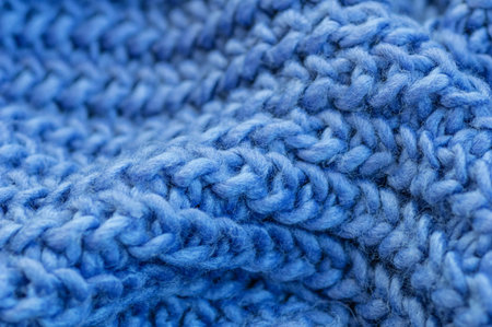 Blue knitted fabric closeup. Knitted wool background. Handmade. Close up.