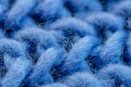 Blue knitted fabric closeup. Knitted wool background. Handmade. Macro.の写真素材