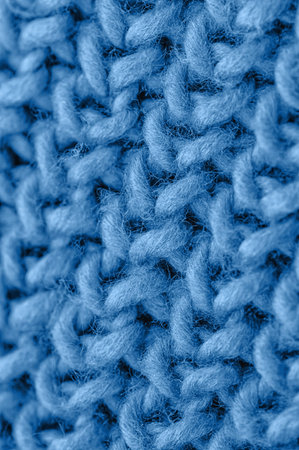 Blue knitted fabric closeup. Knitted wool background. Handmade, close up.