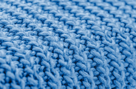 Blue knitted fabric closeup. Knitted wool background. Handmade. Close up.