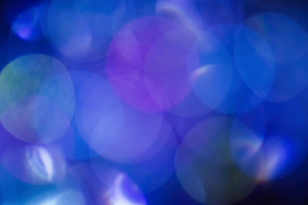 Blue abstract blurred shiny glitter lamp lights background. Abstract blurred highlights.