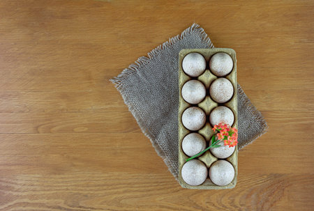 Turkey eggs in pressed paper packaging. Wood background. Easter concept. Flat lay. Copy spase.