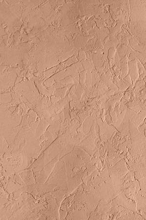 Abstract concrete wall texture for background. Color peach gelato. Copy space. Close up.の写真素材