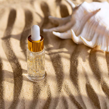 Moisturizing face serum in a clear bottle. Marine background. Close up.の写真素材