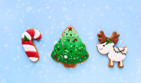 Homemade gingerbread cookies in the form of New Year's decorations on a blue background. Christmas...