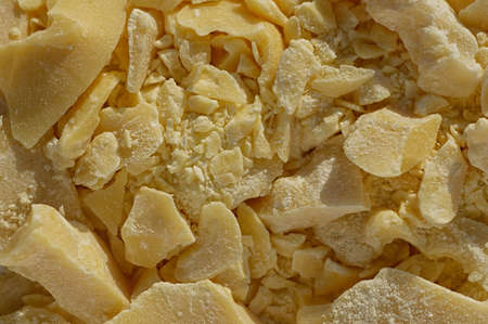 Pieces of crushed cocoa butter. Chopped cocoa oil, a natural ingredient in the pharmaceutical and medical industry. Close up.の写真素材