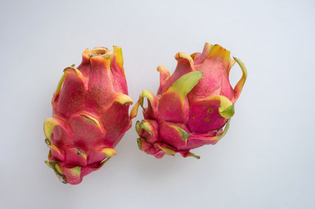 Two ripe pitaya fruits or dragon fruit on a light background. Closeup. Copy space.の写真素材