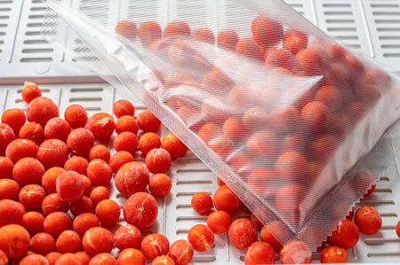 A vacuum sealed bag filled with frozen cherry tomatoes.