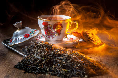 Tea with cookies and cakes on a wooden table.の写真素材