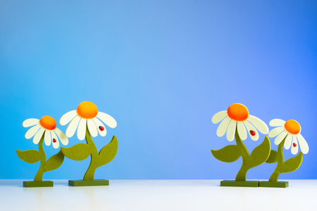 Needlework. Made by hands. Daisies on a blue background. Application. Homemade daisies. Creation....